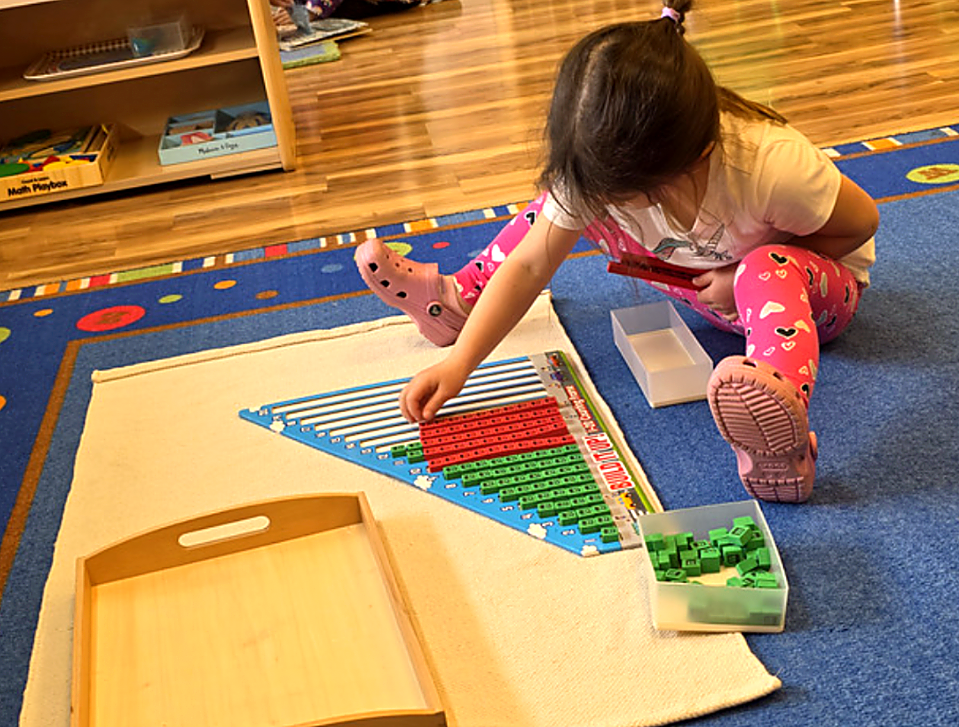 Child working with Montessori classroom materials